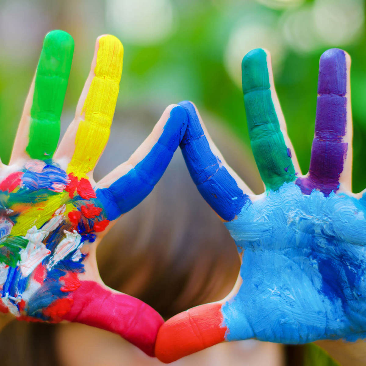 Pupils-learning hands covered in coloured paint