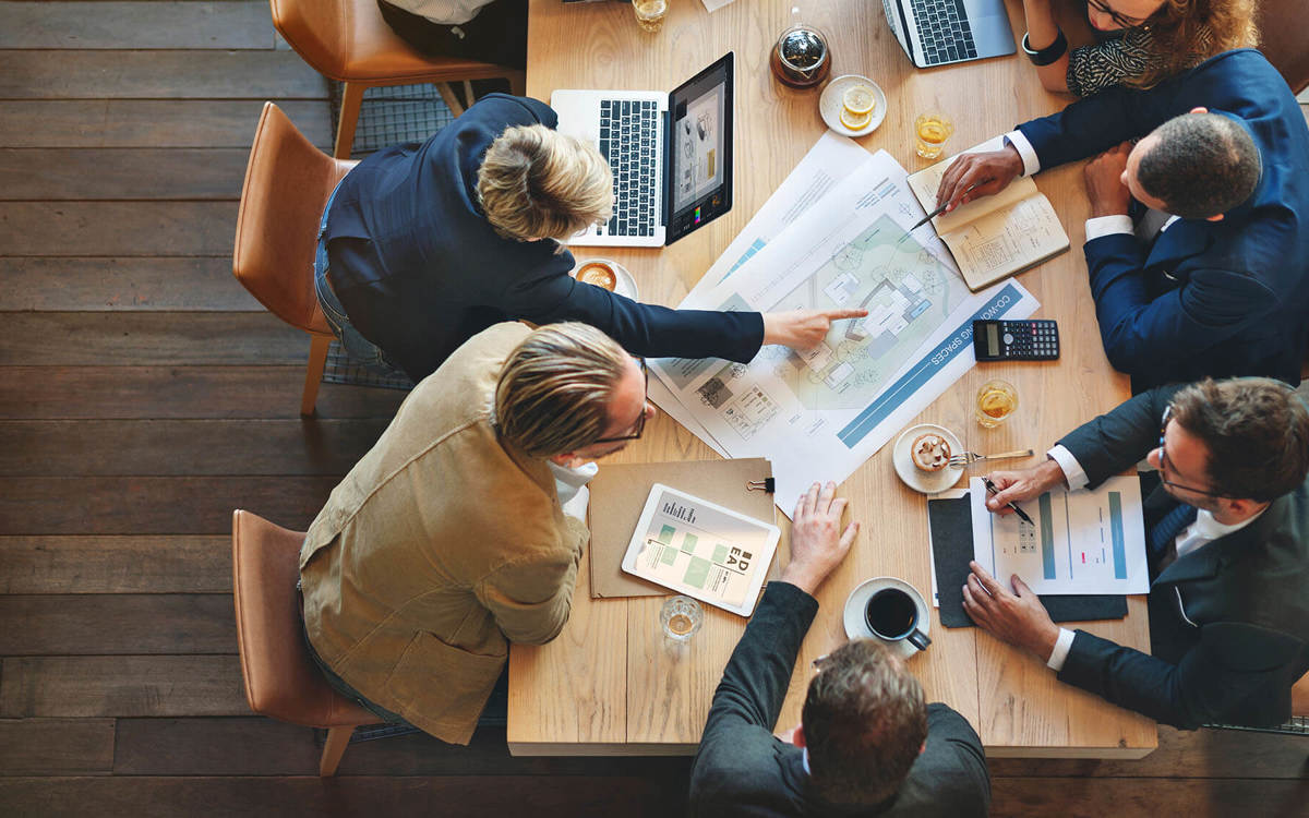 People discussing paperwork at a meeting