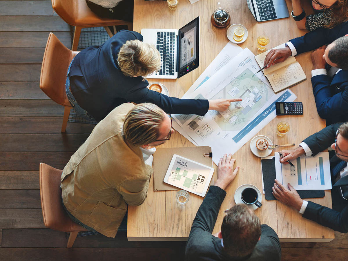 People discussing paperwork at a meeting