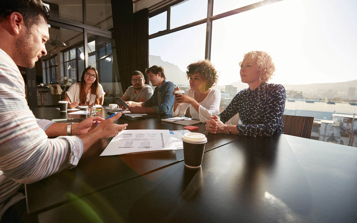 people talking at a table during a meeting