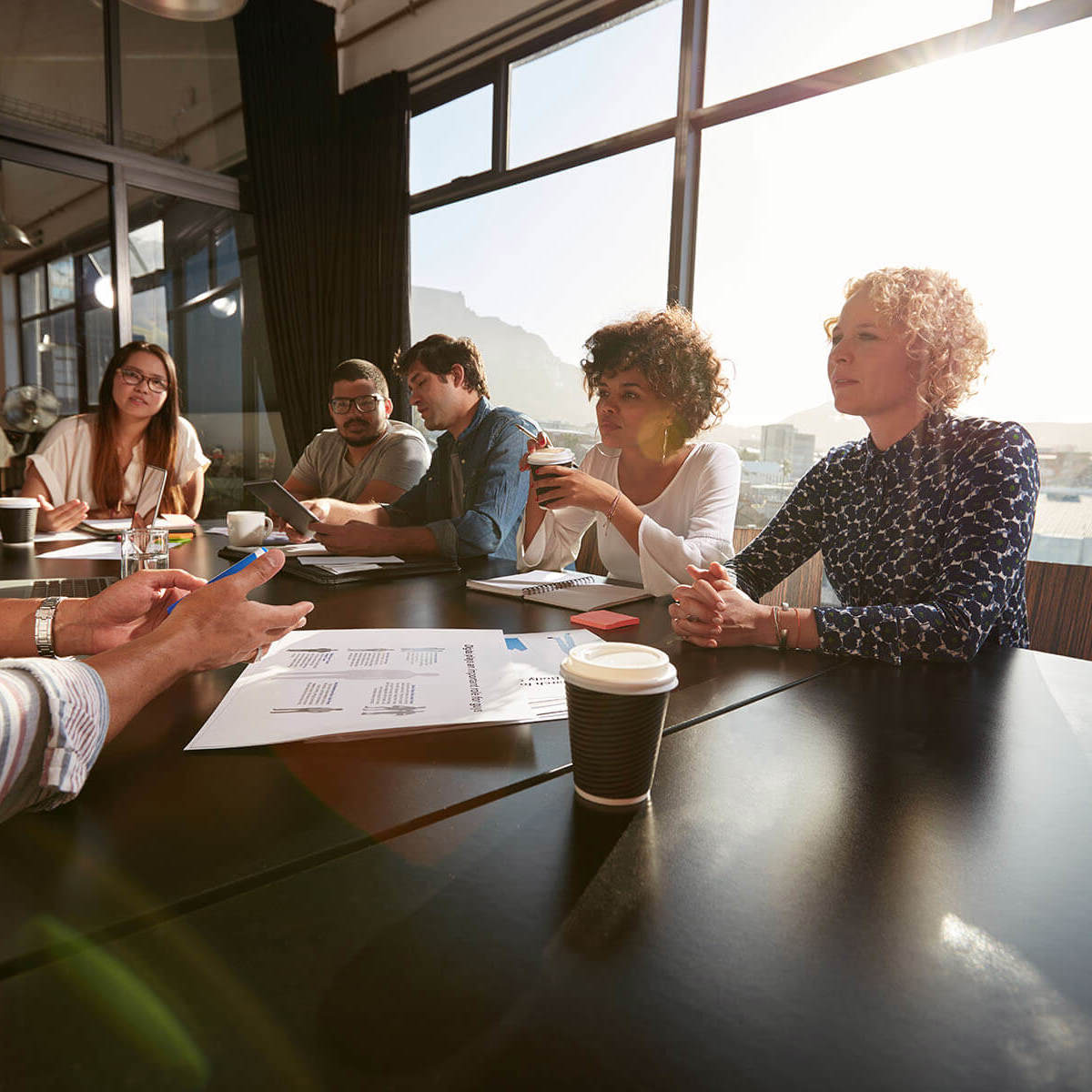 people talking at a table during a meeting