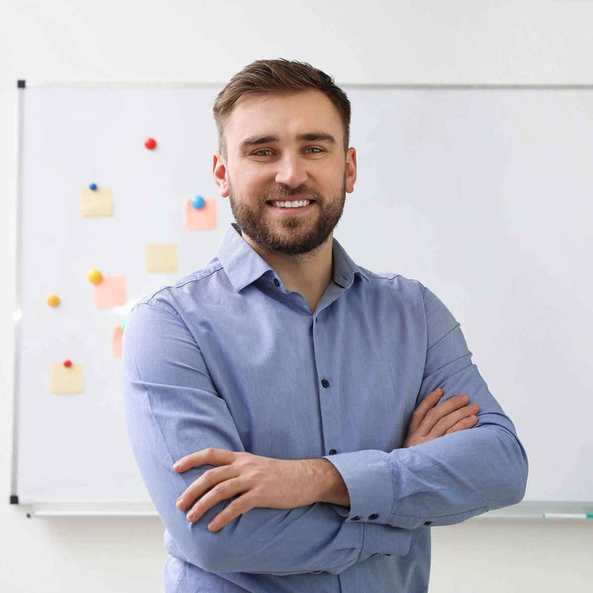 people man smiling in front of whiteboard
