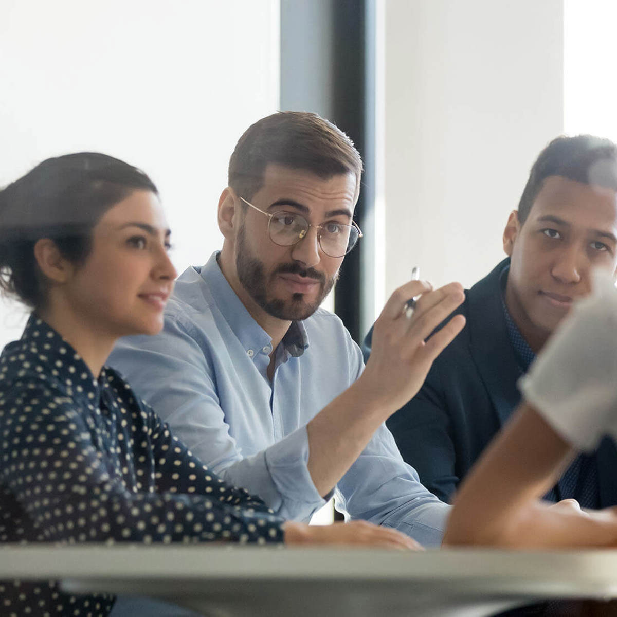 man discussing something with colleagues in a meeting