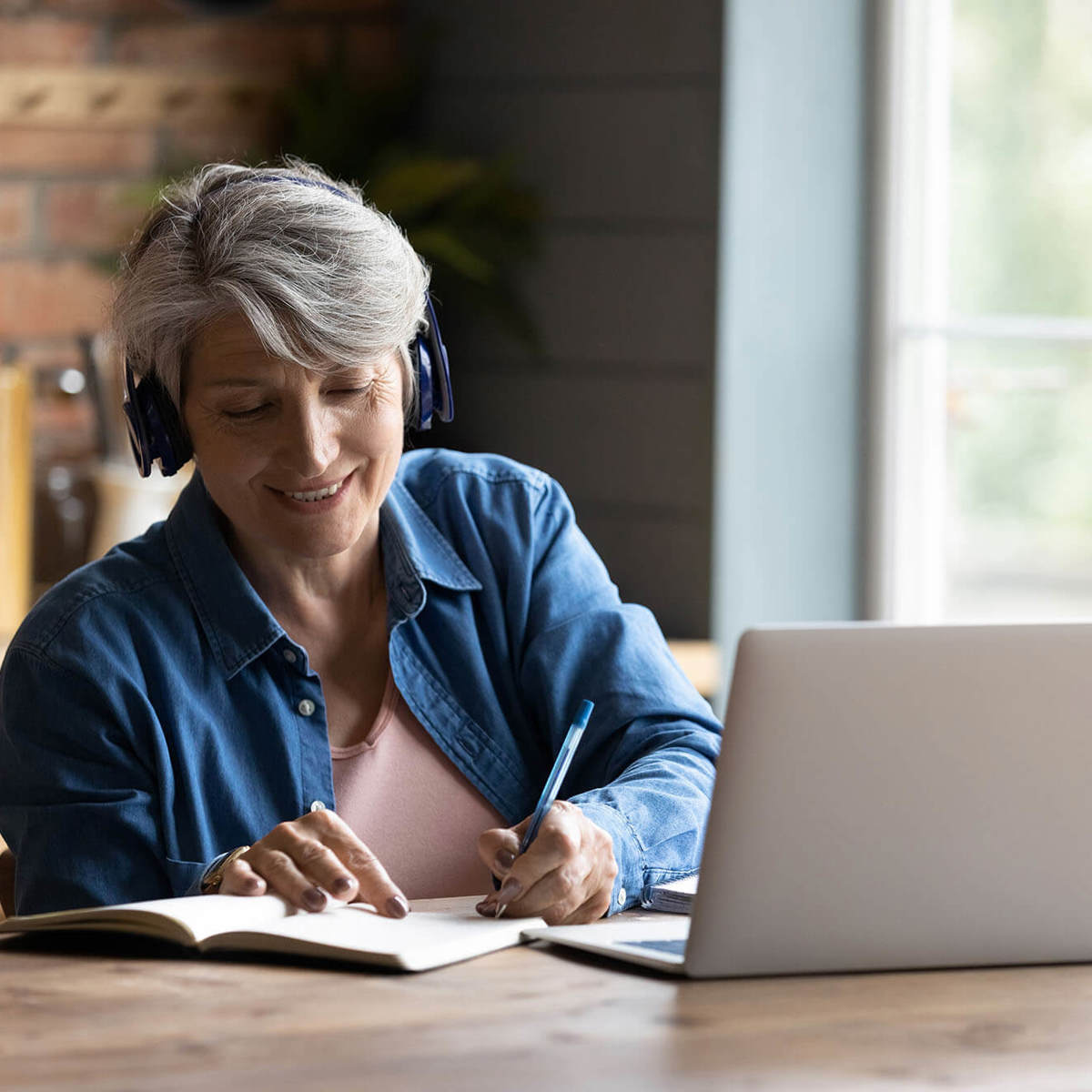 people woman writing notes off her laptop