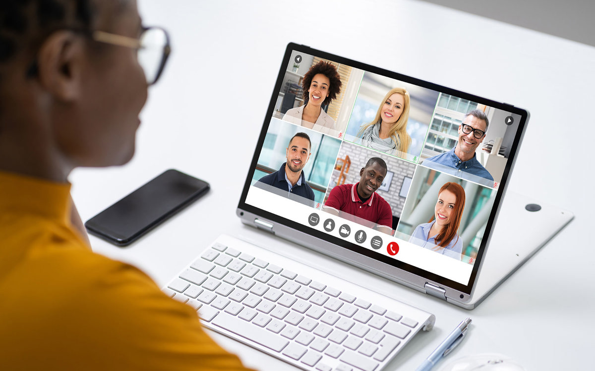 training woman on a video call with six others