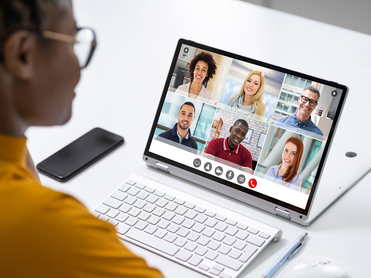 training woman on a video call with six others