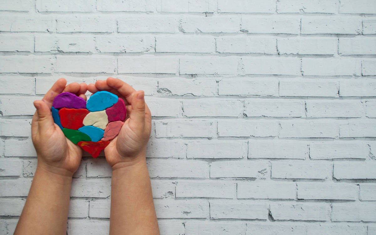 someone holding a molded clay heart