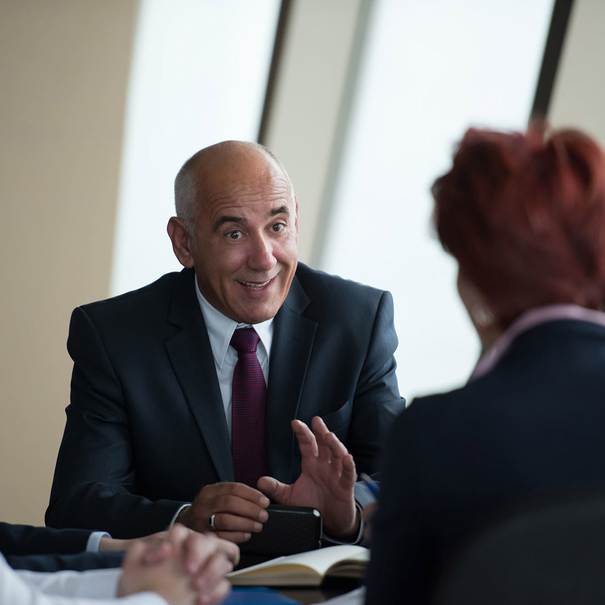 training senior man discussing to a blurred group