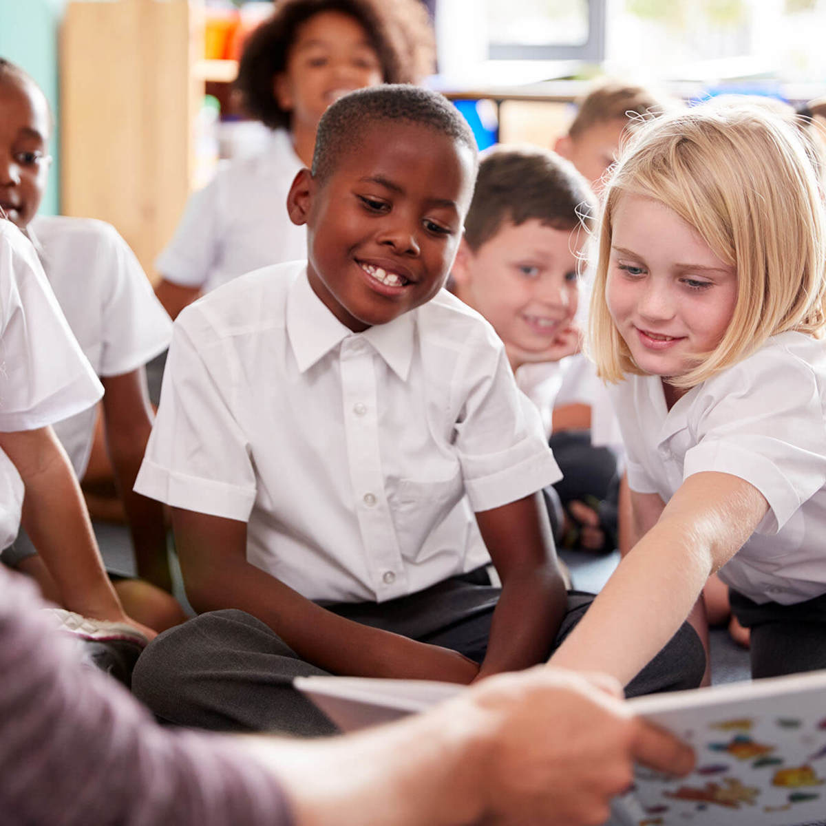 school-environment pupils and the teacher reading together