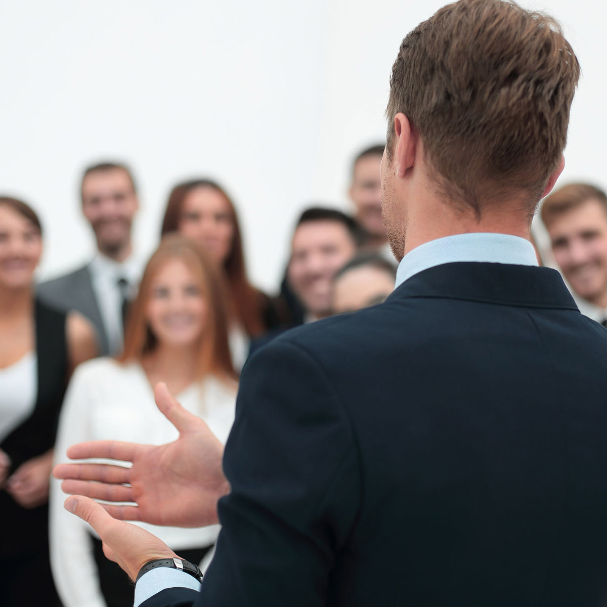 training man instructing blurred crowd