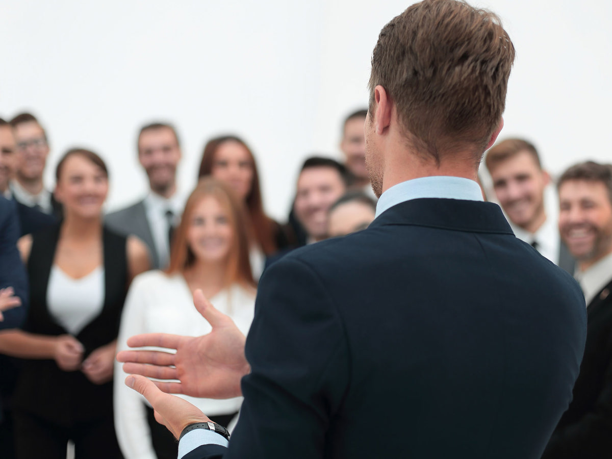 training man instructing blurred crowd