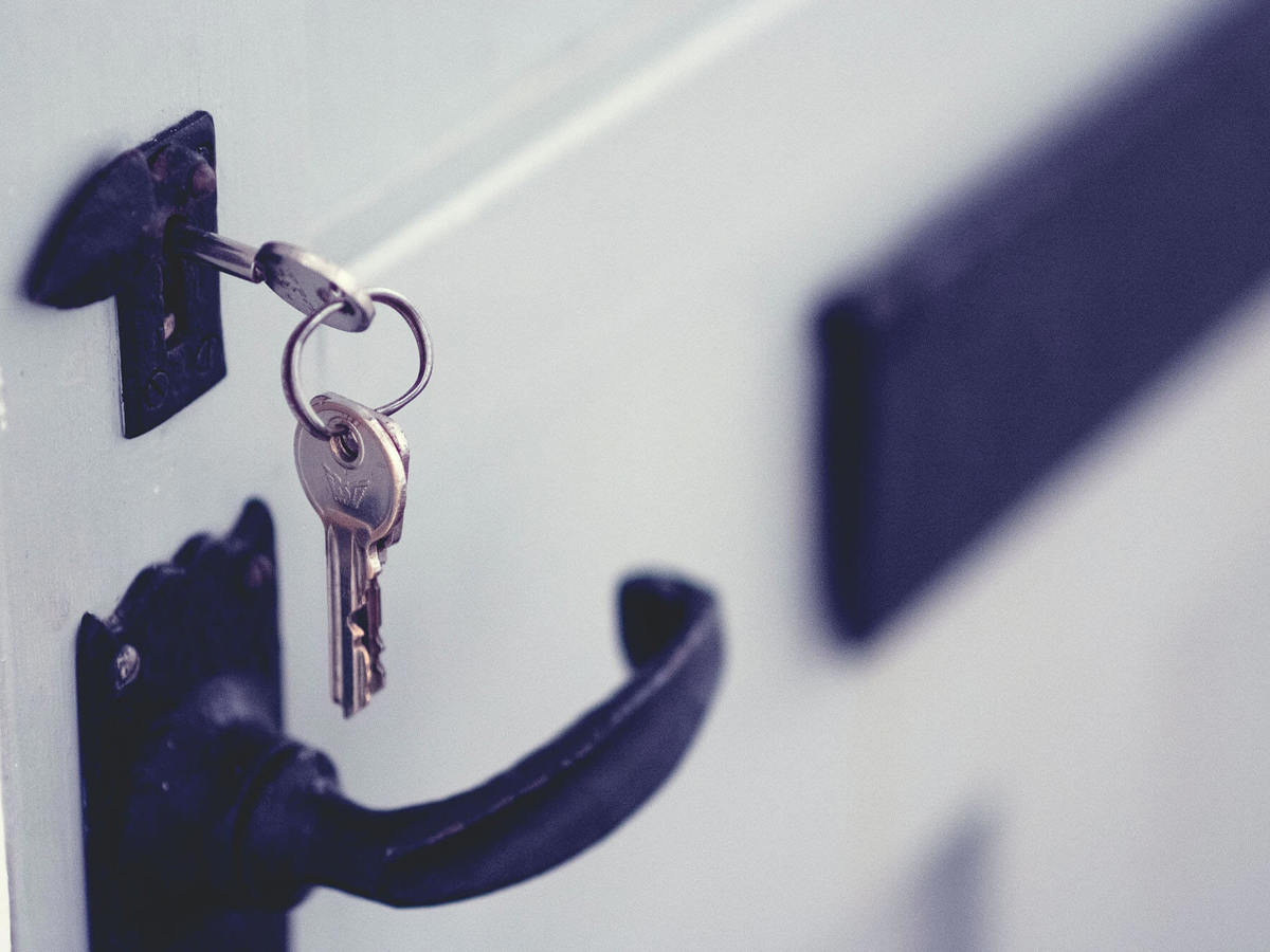 tools-resources keys hanging from the lock of an open door