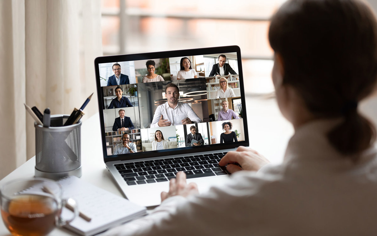 training woman on a video call with thirteen others
