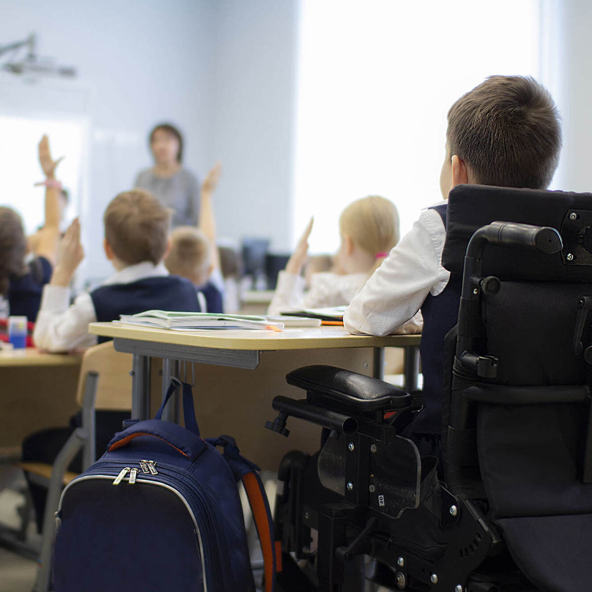Pupils-learning blurred full classroom with a special educational needs and disabilities pupil learning