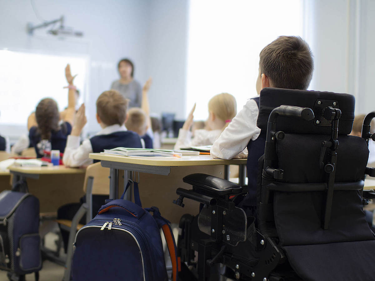 Pupils-learning blurred full classroom with a special educational needs and disabilities pupil learning