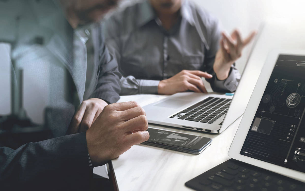 tools-resources two people looking at their phones and laptops