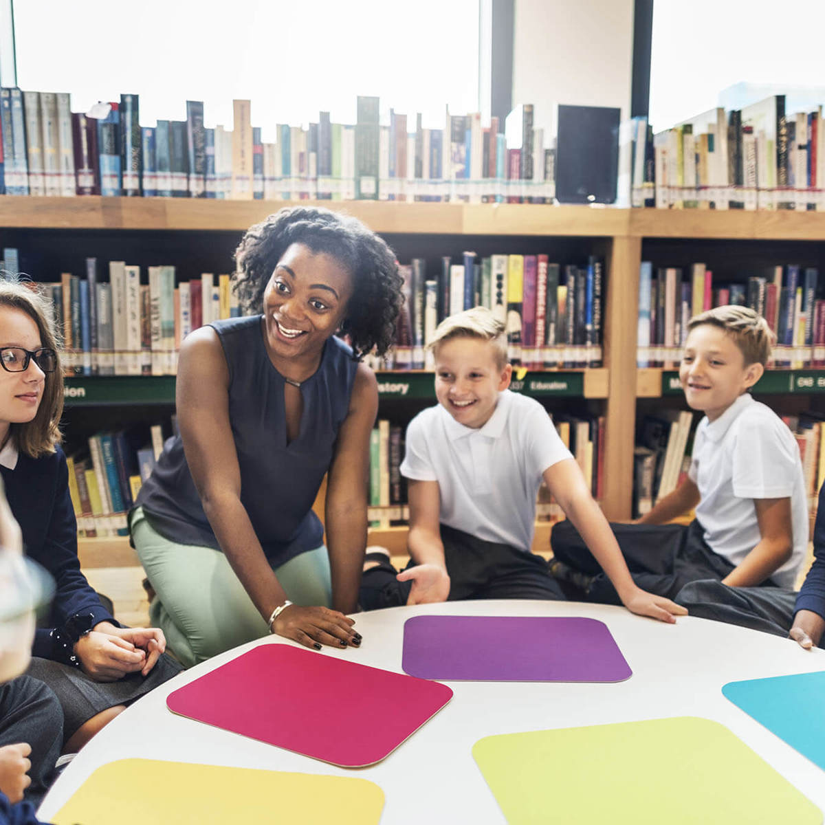 Pupils-learning class learning in the library around a table