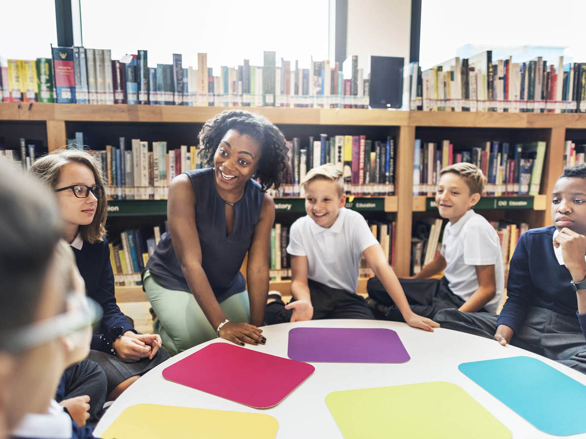 Pupils-learning class learning in the library around a table