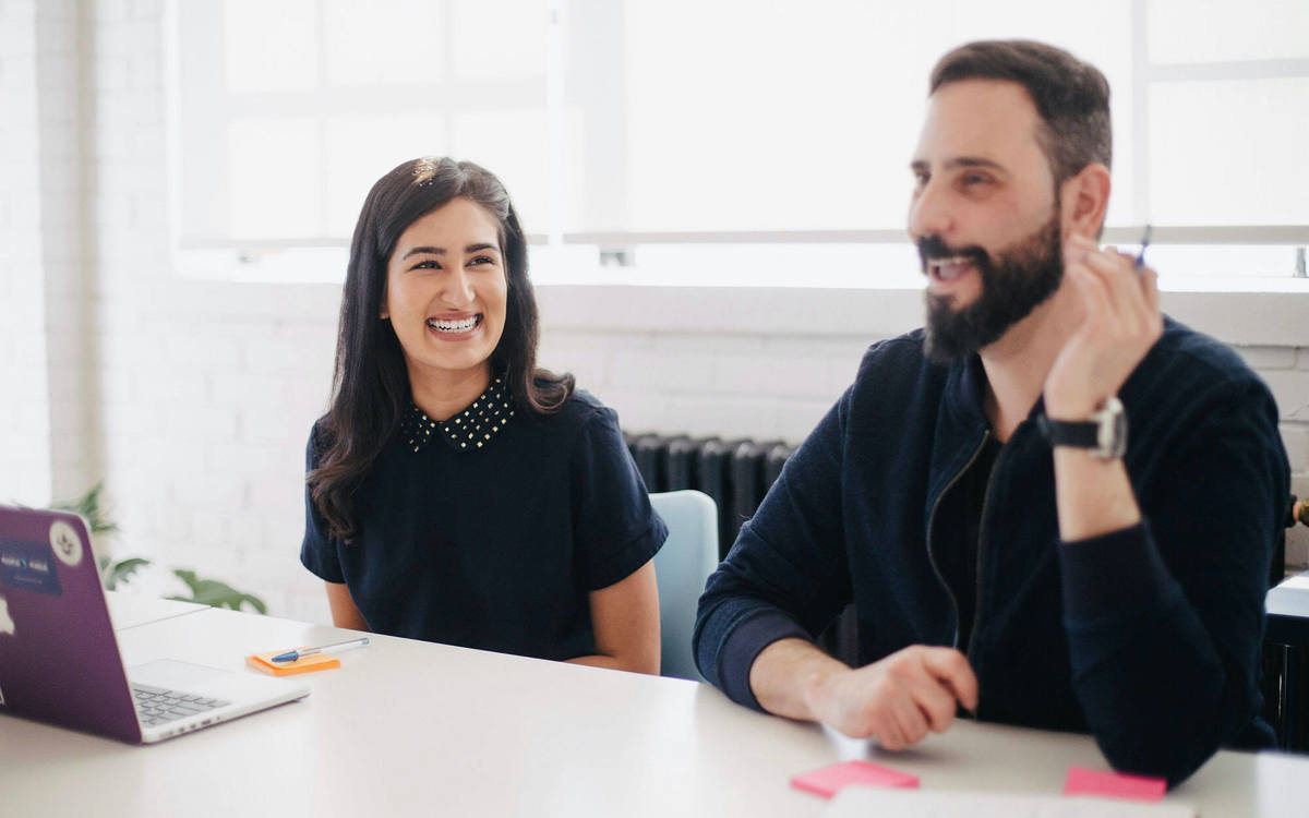Lady and man smiling during a meeting
