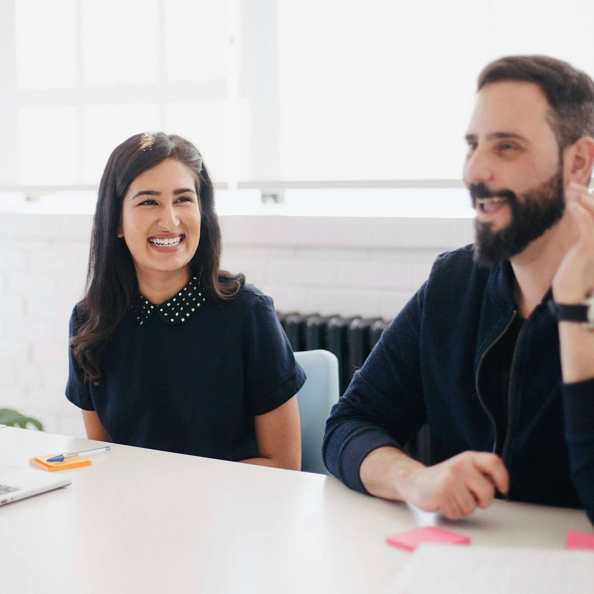 Lady and man smiling during a meeting