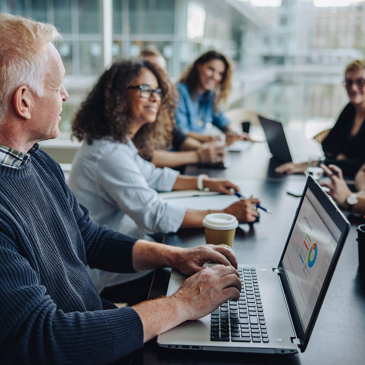 Man on his laptop in a meeting room 