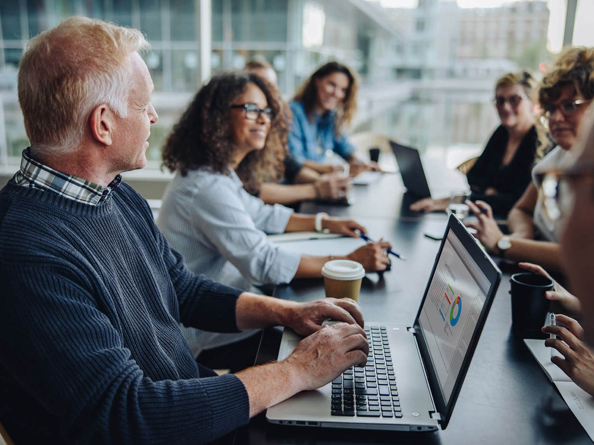 Man on his laptop in a meeting room