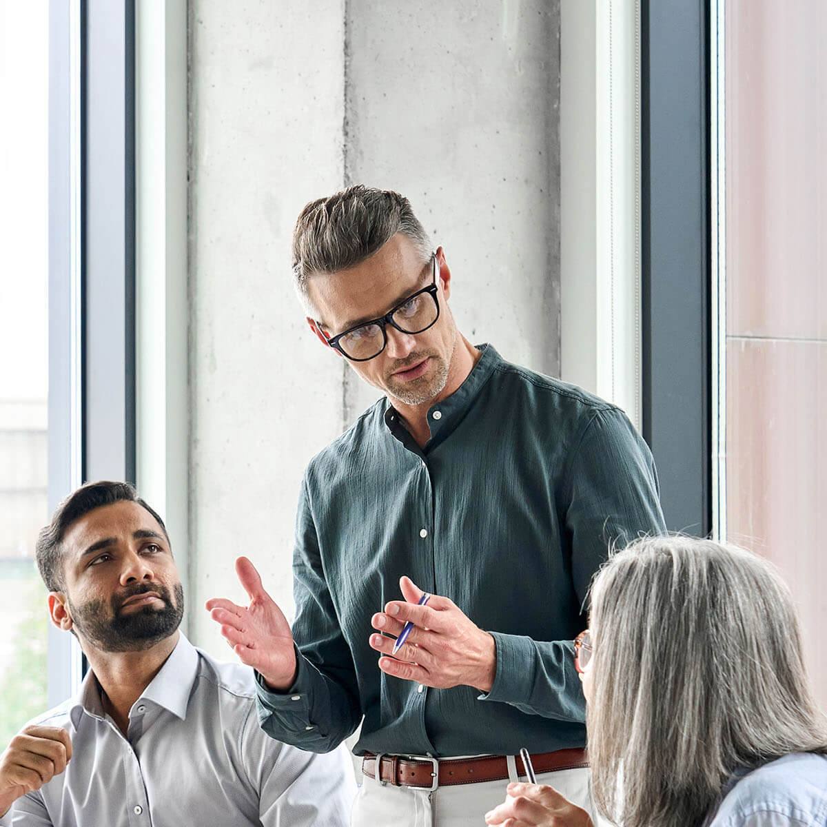 Man talking to two people in meeting