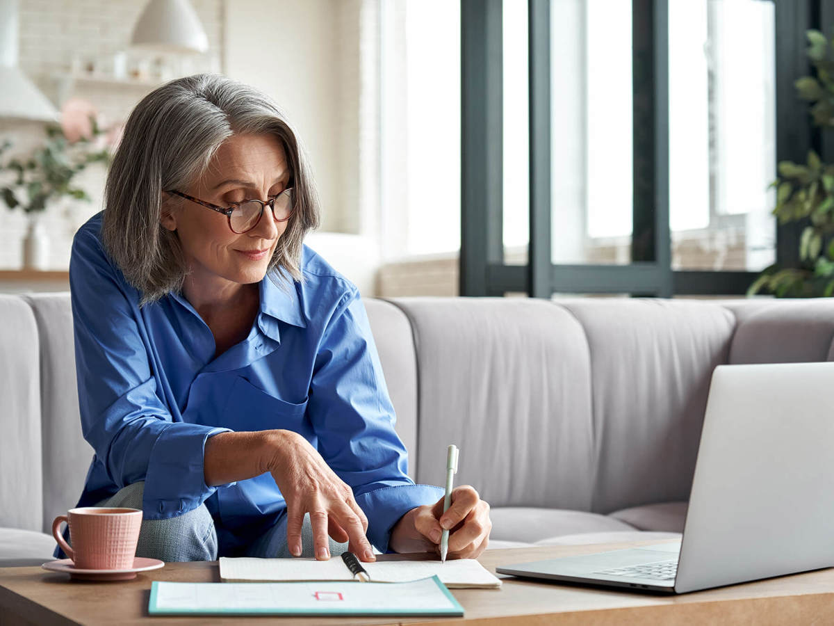 people woman writing notes off her laptop