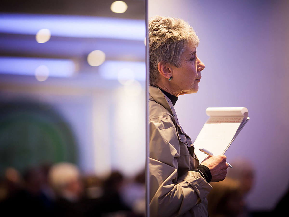 training woman standing with paper in blurred background