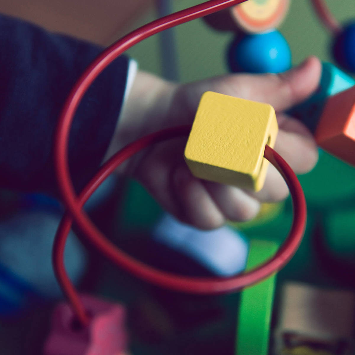 tools-resources child playing with bead maze