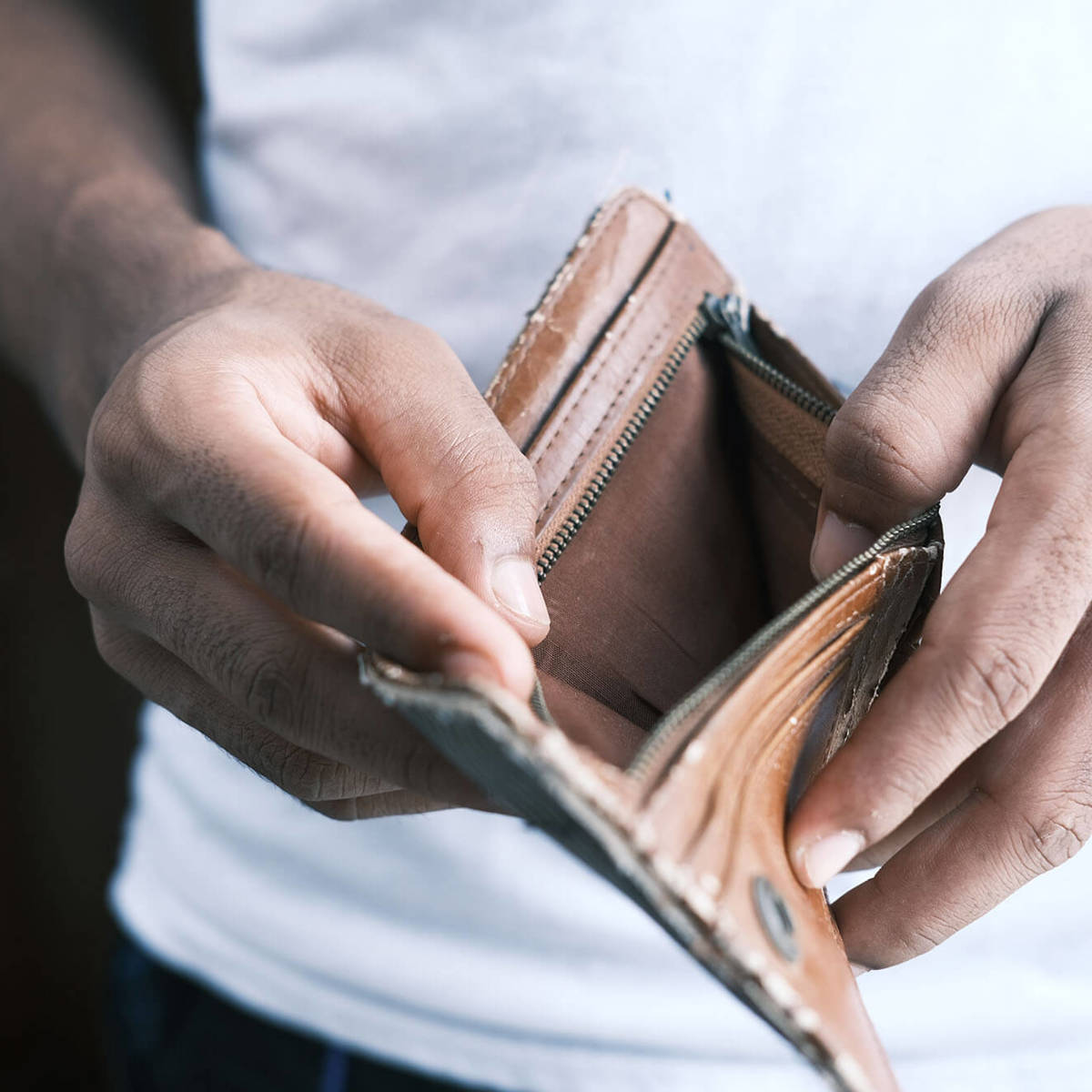 tools-resources man checking empty wallet