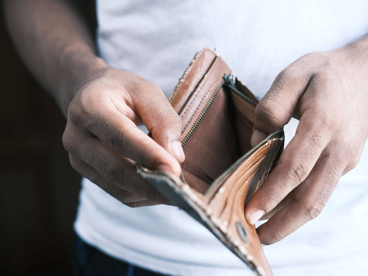 tools-resources man checking empty wallet