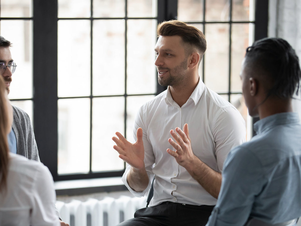 training man cheerfully talking to a small group