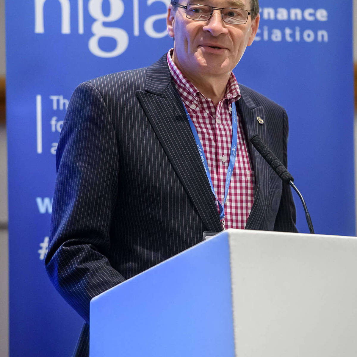 NGA representative speaking on the stand at a conference event