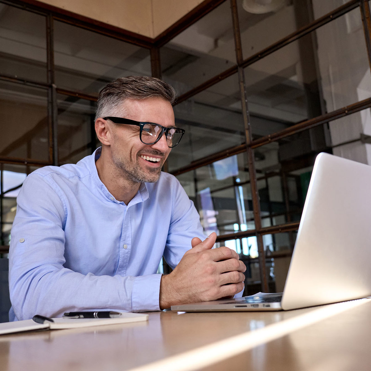 training man smiling at his laptop