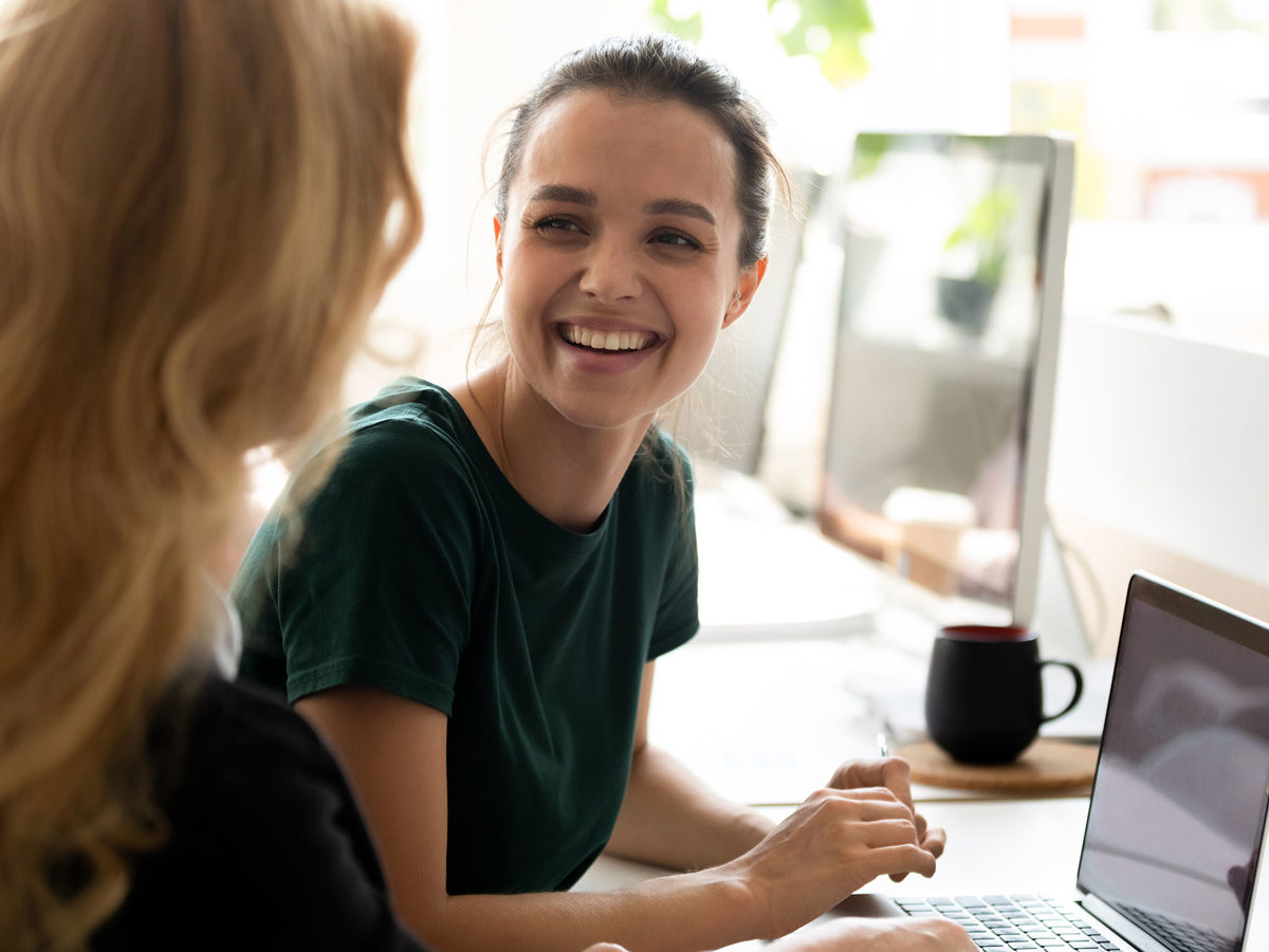 training two women cheerfully talking to each other