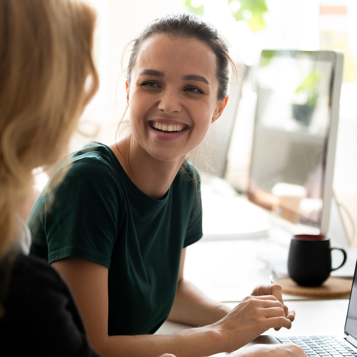 training two women cheerfully talking to each other