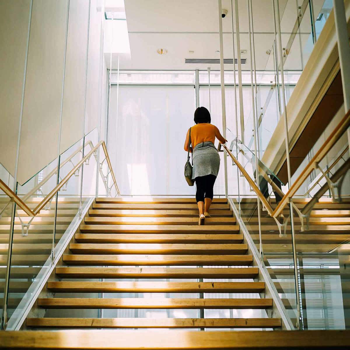 school-environment woman walking up flight of stairs