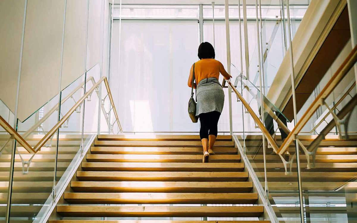school-environment woman walking up flight of stairs