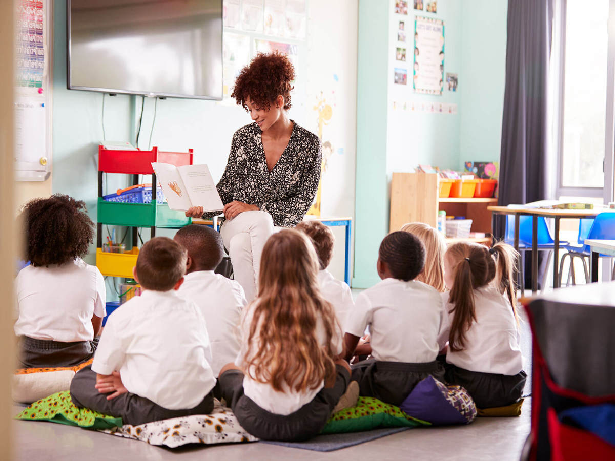 school-environment young pupils in class reading with the teacher