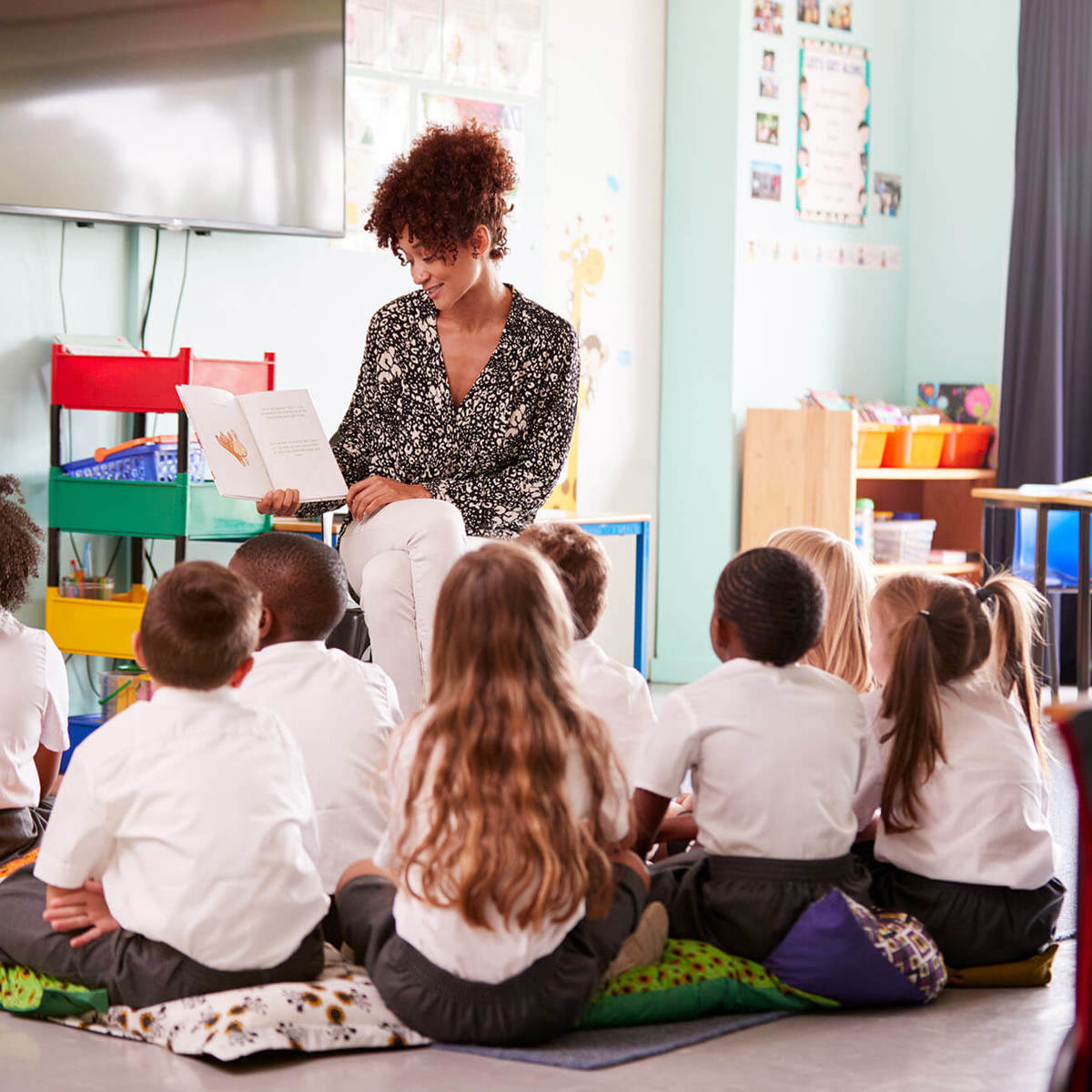 school-environment young pupils in class reading with the teacher