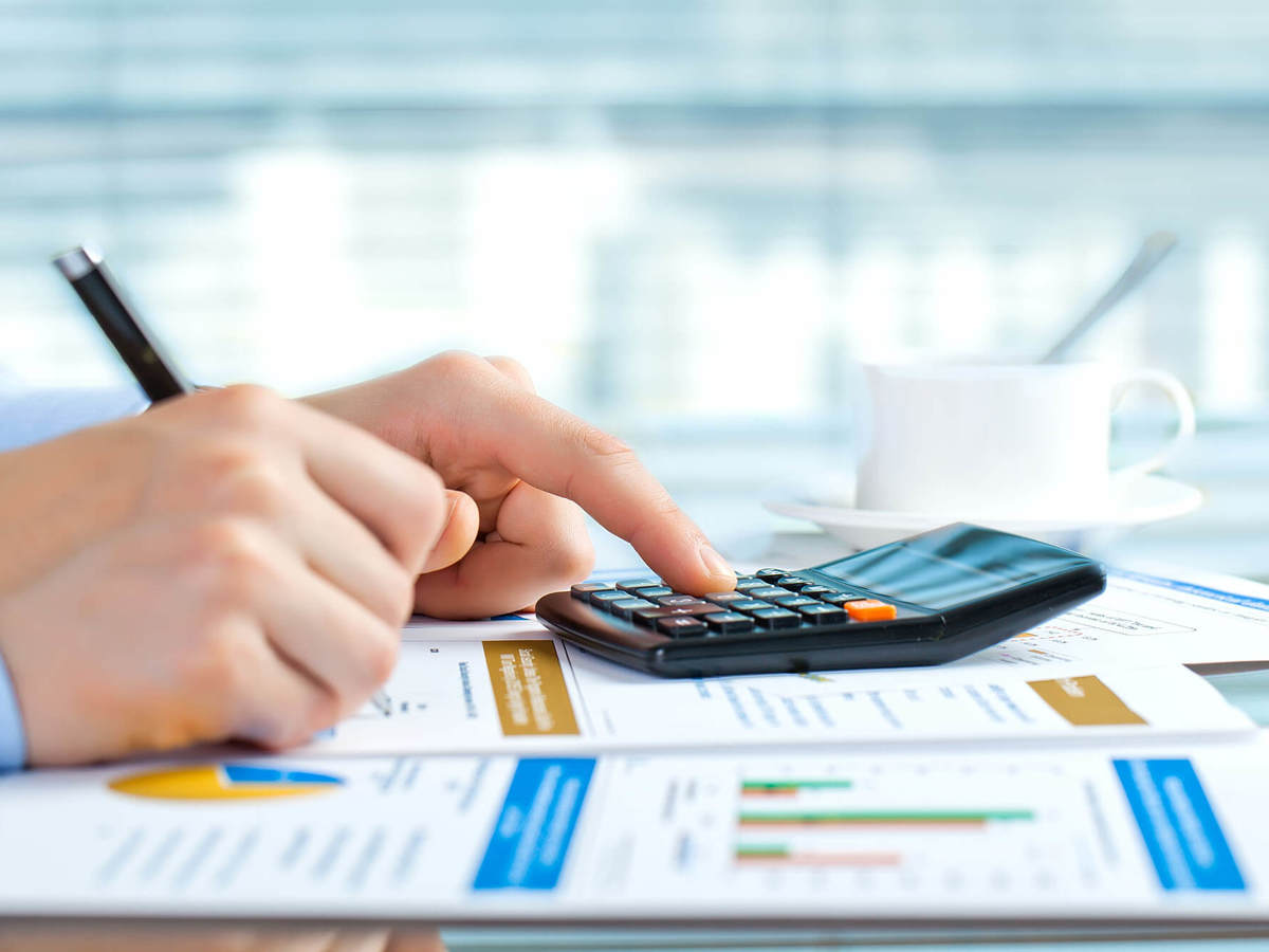 tools-resources someone using calculator and writing