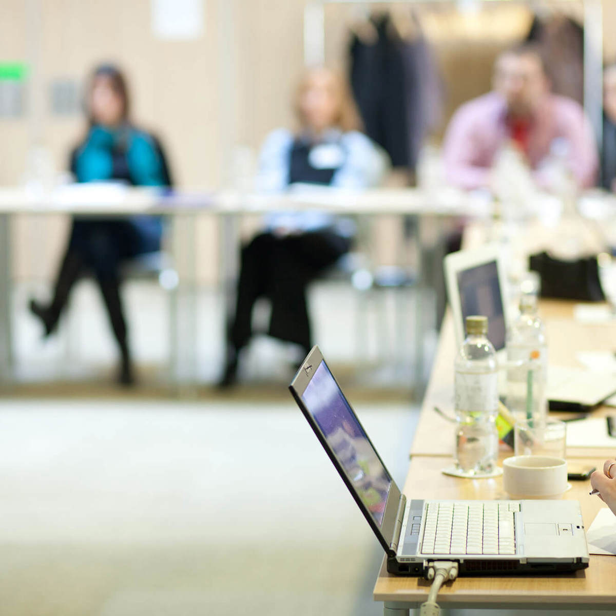 training people around table with laptops