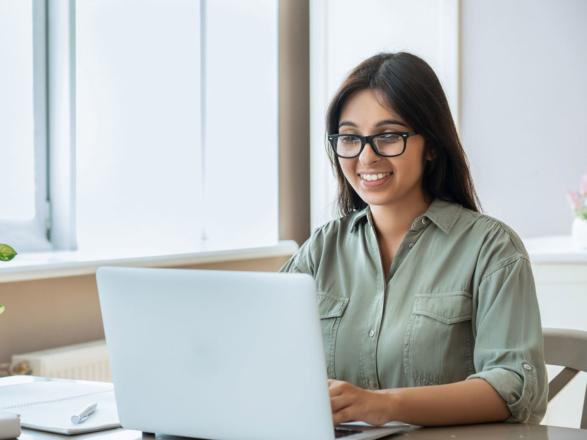 training woman on laptop smiling