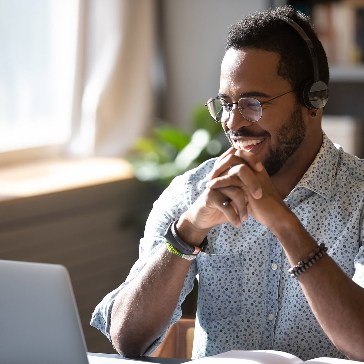 training man smiling at his laptop