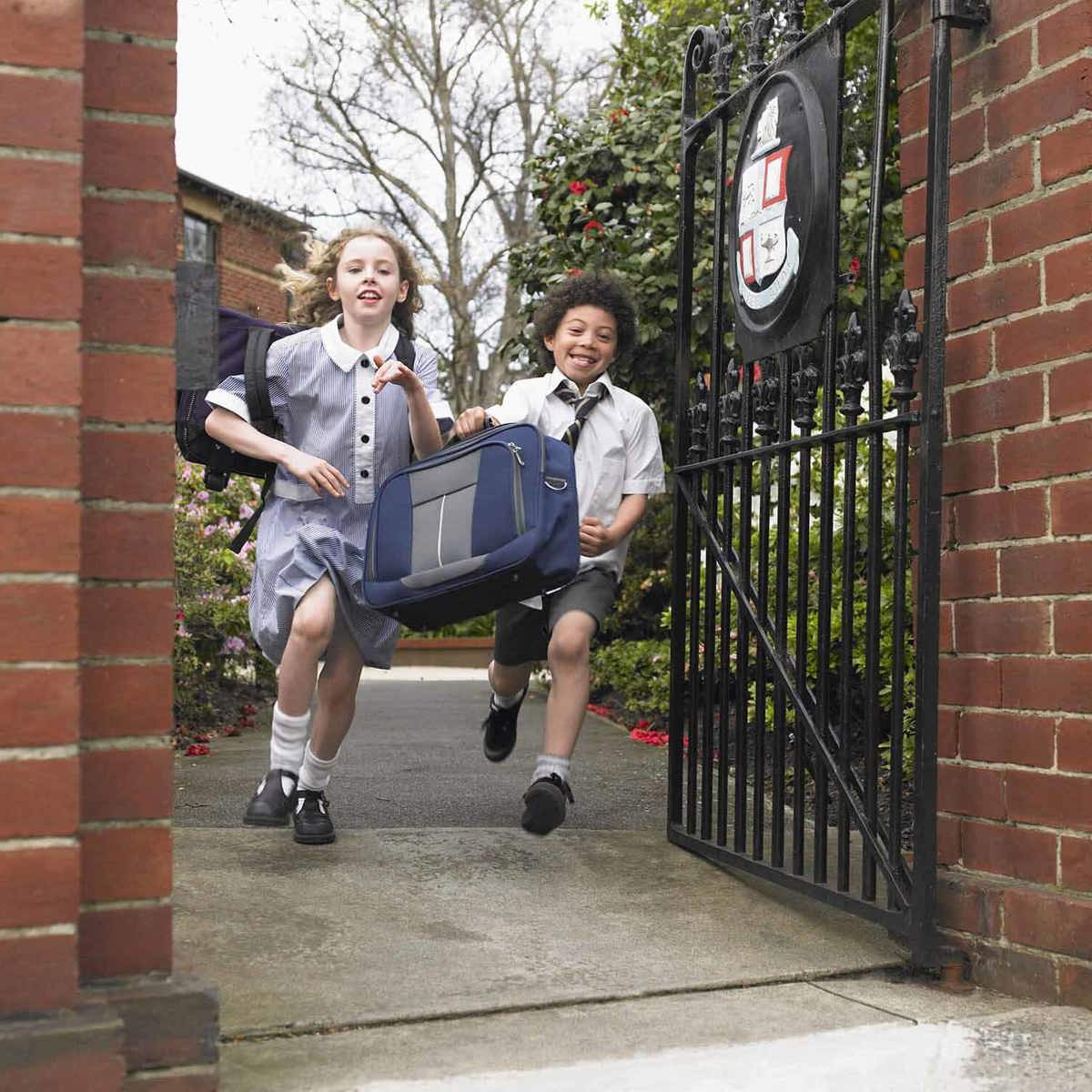 Pupils-learning young pupils running out of their school gates