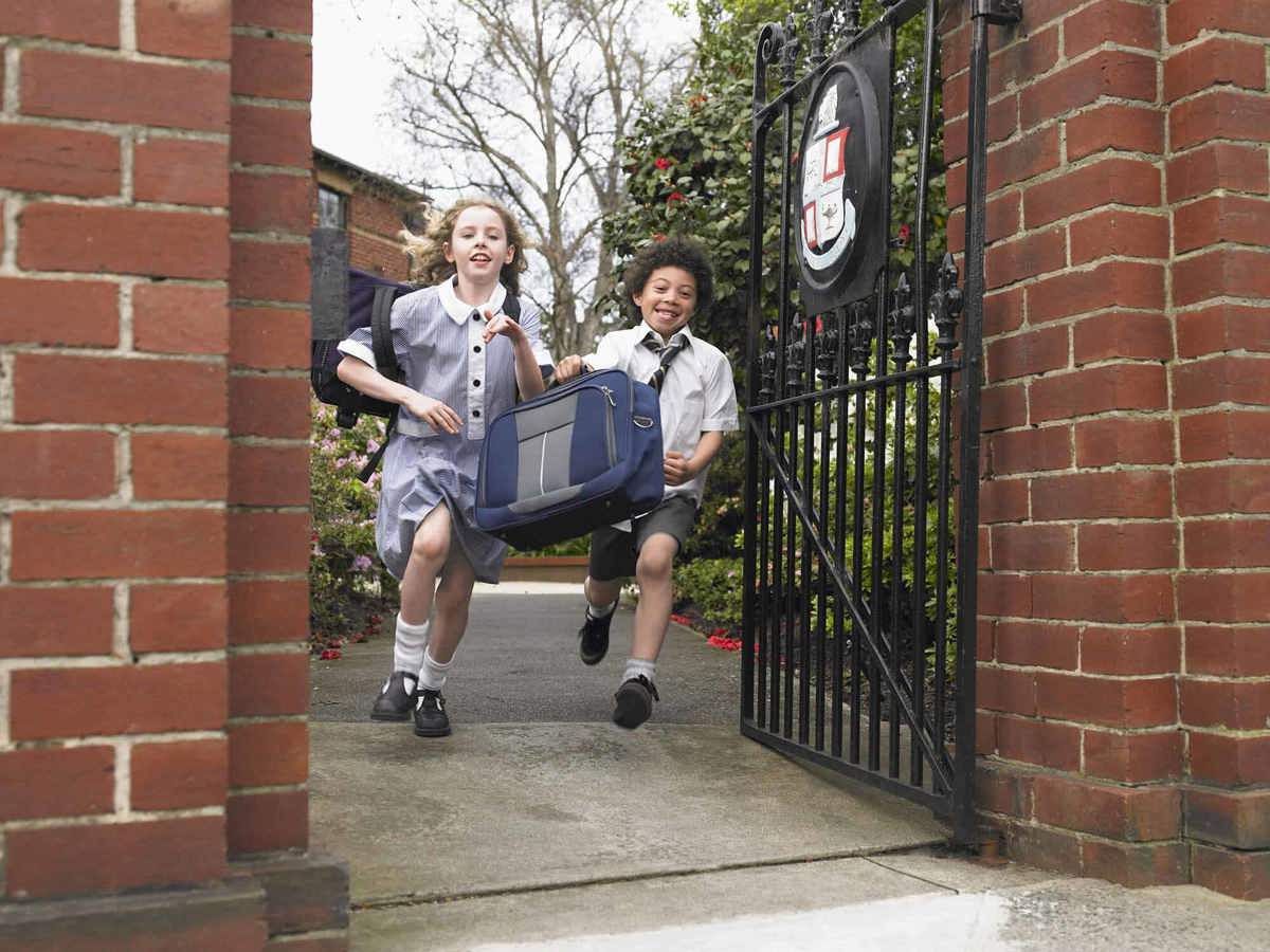 Pupils-learning young pupils running out of their school gates