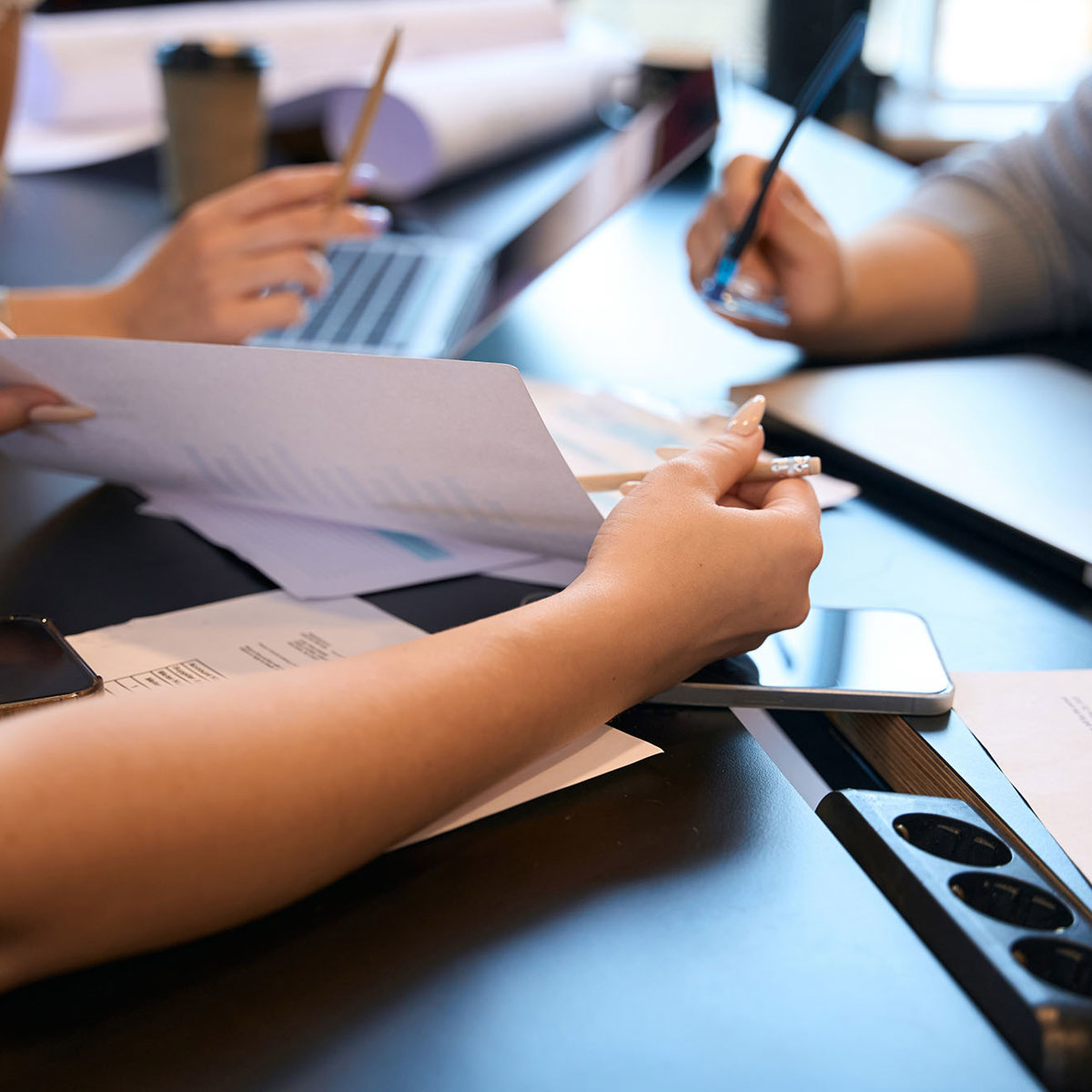 training three people at a tablet discussing notes