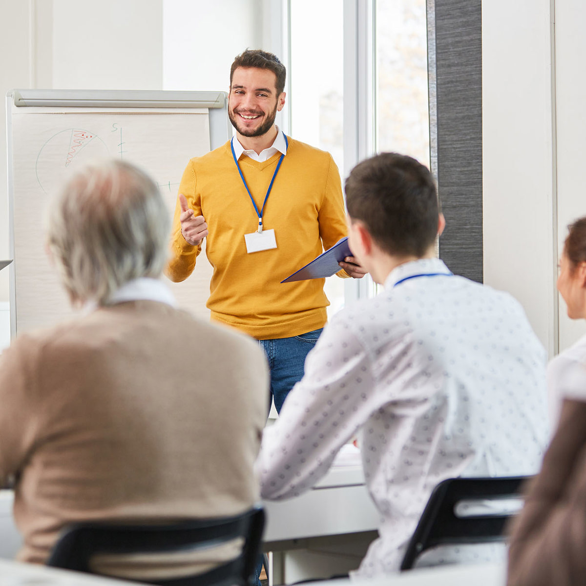 training man presenting to group of people