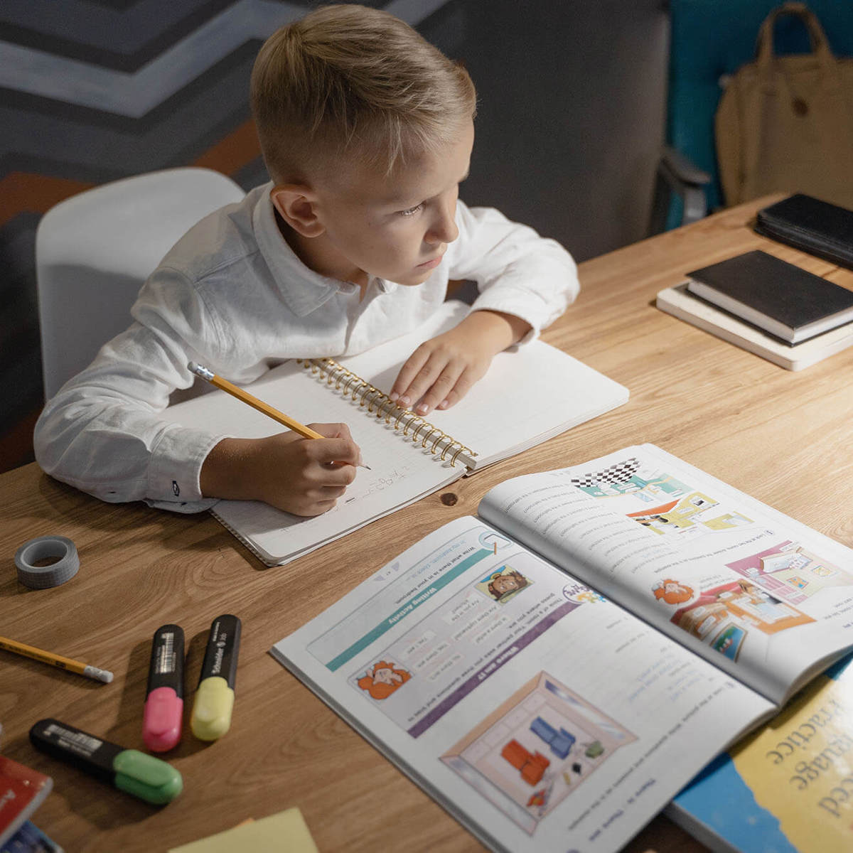 Pupils-learning writing into a book from learning material